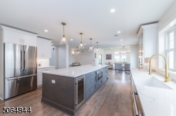 Upscale chefs kitchen  with 48" stove, designer hood, wine fridge, undercounted microwave, french door refrigerator and more