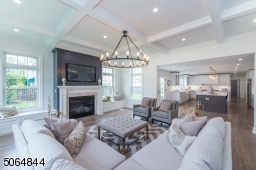 Family room open to kitchen floor to ceiling fireplace and 14 foot coffered ceiling
