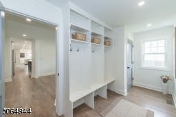 Off garage and open to hallway with dining room and living room