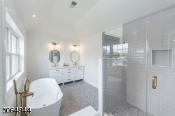 Master bath with two sinks, soaking tub, large walk in shower