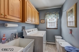 Located on the first floor. Laudry room is 5'.9" x 8'.9" with oak cabinets and utility sink.