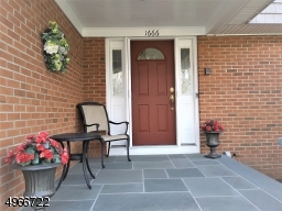 Open Bluestone Front Porch and Entrance. Retractable front screen door also in side garage door and basement bilco door.
