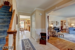 Entrance Foyer is 9" x 7' with tiled flooring and wainscoting crown molding.