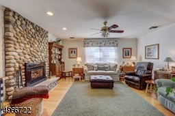 Family Room is 16' x 16'. Stone wall with a gas fireplace and oak wood flooring. Central vacuum connection.