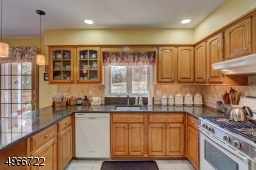 Plenty of maple cabinets and quartz countertops.