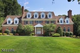 Pull into this estately drive with 3-car garage and expressive front lawn.