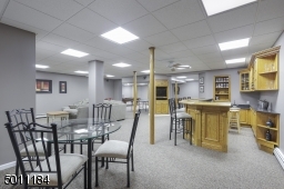 WOW!  It just doesn't get more spacious, fun or rec room perfect than this.  Wet bar, game area, lounge area, 2 finished rooms that can be used for an exercise room or craft room!