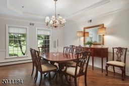 Beautiful tray ceilings, newly finished wood floors and freshly painted wall give this dining room the desire to entertain today!