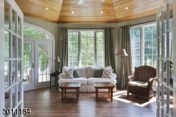 Overlooking the patio/pool, surrounded by windows and sunlight, enjoy your morning coffee in this cozy room /