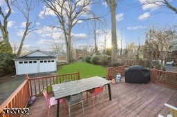 Oversized Wood Deck overlooking the level rear yard and  2 Car detached garage