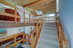 Steps to Loft space, wood clad beamed ceiling