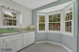Eat-in kitchen w/ large bay window overlooks the beautiful backyard.