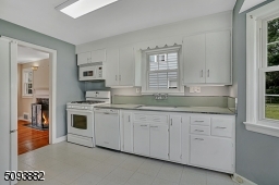 Eat-in kitchen w/ large bay window overlooks the beautiful backyard.