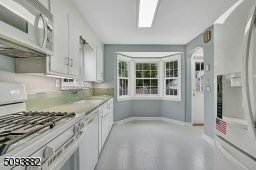 Eat-in kitchen w/ large bay window overlooks the beautiful backyard.