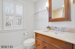 Full Hallway Bathroom with modern subway tiles and custom Plantation shutters.