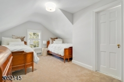 Bedroom 4 featuring hardwood floors, double closet, and access to back hallway