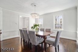 Dining Room is open to Foyer and features hardwood floors, chair rail, built-in corner china cabinet and 2 exposures of windows