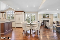 A tremendous open concept Family Room / Gourmet Chef?s Eat-In Kitchen with top-of-the-line WoodMode custom cabinetry, high-end appliances and center island seating.