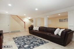 Family room with Wet Bar with Schuler Cabinetry, Granite CountertopRecessed Lighting, Half Bathroom,