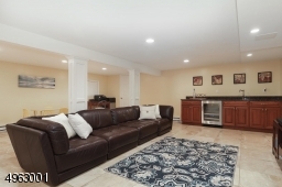 Family room with Wet Bar with Schuler Cabinetry, Granite Countertop,Recessed Lighting, Half Bathroom,