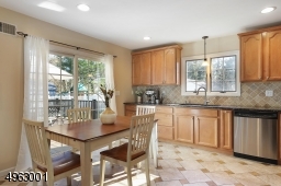 Sunlit breakfast area with slider door access to laege deck.