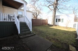 Covered porch overlooks back yard