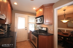 Another view of Kitchen, showing adjacent Dining Room.  Gas range, Microwave, and Refrigerator are included