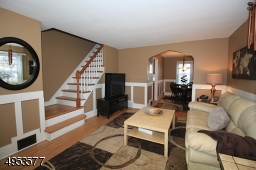 View of Living Room and staircase leading to 2nd floor.  Hardwood floors in LR, DR, staircase
