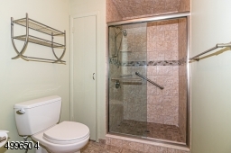 Tiled shower with glass door.