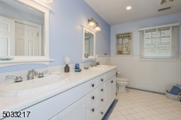 2nd floor main bath with double sinks with shower over Jacuzzi tub.