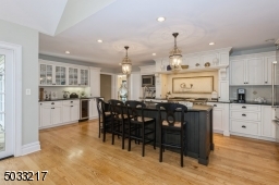 Oversized  Center Island, wet bar, wine refrigerator and updated high end appliances with  pot filler over stove