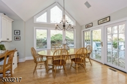 Expansive eat in area with vaulted ceiling and large picture window provide open and airy space