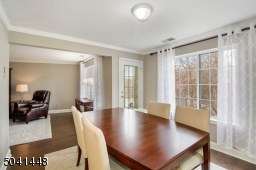 Inviting Dining Room with picture window overlooking woodland/pond views and balcony access.