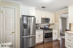 New Kitchen features stainless steel appliances including French door refrigerator and built-in microwave, plus  full-sized pantry.