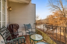 Charming balcony hosts lovely, peaceful views of community pond with fountain.