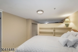 Lower level partition wall divides the space into two areas. Current owners use one side as an additional guest suite with dedicated full bath, and the other as a home office.
