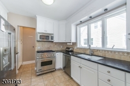 This delightful eat in kitchen featuring top-notch stainless steel appliances and custom cabinetry is a great space for prepping meals while keeping an eye on the little ones in the fenced in back yard.
