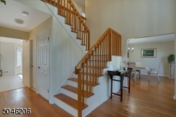 Dramatic double height foyer. Hardwood flooring throughout this fine home.
