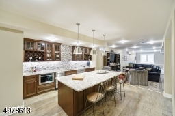LOWER LEVEL HAS FITNESS AREA , WET BAR, MEDIA, GAME ROOM AND PLAY AREA LEADING OUT TO PATIO AND LAKE