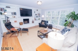 This room is amazing with large windows, built-in shelving around the fireplace.