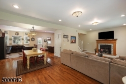 Note the gas fireplace in the living room and the beautiful hardwood floors