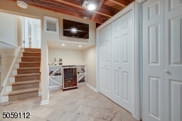 In front of hanging tv and wine bar area