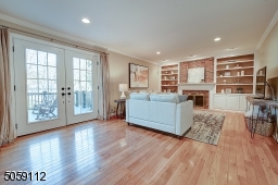 Beautiful french doors out to expansive composite deck with awning.  Wood burning fireplace with brick and built in bookcase surround.