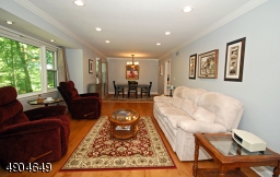Just off the entrance foyer is the formal living room with gorgeous maple flooring that runs through to the dining room.