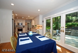 From this angle, you can enjoy the wall of window and sliding door with views of the beautifully landscaped tiered terraces and large patio.
