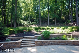in 2018, the seller designed this amazing terraced rear yard and finished it with a lovely perennial garden. From the kitchen and family room, this is the view!