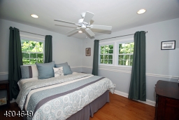 features recessed lighting, a ceiling fan light, chair rail and maple flooring.