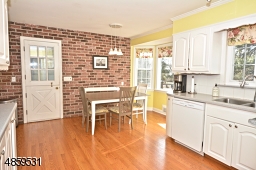 Beautiful large kitchen with brick face wall and door to brand new large TREX Deck