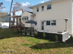 Fully fenced backyard with patio and deck.