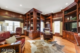 First floor Office with hardwood floor, custom built-in book shelves and cabinetry.